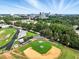 Picturesque aerial view shows a baseball field, trees, and the city skyline at 1904 Smallwood Dr, Raleigh, NC 27605