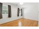 Bedroom with hardwood floors, curtains and natural light from the window at 1904 Smallwood Dr, Raleigh, NC 27605