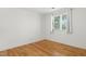 Bright bedroom featuring hardwood floors and a window offering natural light at 1904 Smallwood Dr, Raleigh, NC 27605