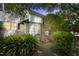 Charming two-story home with a stone facade, complemented by lush landscaping and a welcoming entrance at 1904 Smallwood Dr, Raleigh, NC 27605