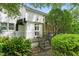 Charming two-story home with a stone facade, complemented by lush landscaping and a welcoming entrance at 1904 Smallwood Dr, Raleigh, NC 27605