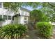 Charming two-story home with a stone facade, complemented by lush landscaping and a welcoming entrance at 1904 Smallwood Dr, Raleigh, NC 27605