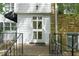 Close up of front door with black railing and stone facade at 1904 Smallwood Dr, Raleigh, NC 27605