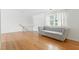 Bright living room featuring hardwood floors and a comfortable gray couch at 1904 Smallwood Dr, Raleigh, NC 27605