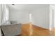 Bright living room featuring hardwood floors and a comfortable gray couch at 1904 Smallwood Dr, Raleigh, NC 27605