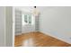 Bright room featuring hardwood floors, built-in shelves, and a window that allows for natural light at 1904 Smallwood Dr, Raleigh, NC 27605
