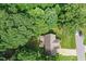 Aerial view of a residential home surrounded by lush greenery and mature trees at 210 Water Oak Way, Louisburg, NC 27549