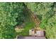 Aerial view of backyard with a shed, trees, patio and fire pit at 210 Water Oak Way, Louisburg, NC 27549