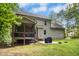 Backyard featuring a screened porch, patio with grill, and a spacious lawn at 210 Water Oak Way, Louisburg, NC 27549