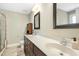 Bathroom with double sinks, large mirror, and walk-in shower provides a functional and stylish space at 210 Water Oak Way, Louisburg, NC 27549