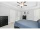 Neutral bedroom features a ceiling fan, tray ceiling, and two closets for ample storage at 210 Water Oak Way, Louisburg, NC 27549