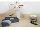Upstairs bonus room with a sofa, TV, ceiling fan, and carpet flooring at 210 Water Oak Way, Louisburg, NC 27549