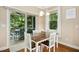 Cozy dining area with a wooden table, sliding doors to the outdoor screened patio, and ample natural light at 210 Water Oak Way, Louisburg, NC 27549