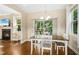 Bright dining room featuring a wooden table, chandelier, and sliding doors to a screened porch, ideal for gatherings at 210 Water Oak Way, Louisburg, NC 27549