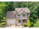 Beautiful two-story home with stone accents, a well-maintained lawn, and a cozy front porch at 210 Water Oak Way, Louisburg, NC 27549