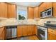 Bright kitchen featuring stainless steel appliances, wood cabinets, and a window over the sink at 210 Water Oak Way, Louisburg, NC 27549