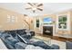 Cozy living room with a fireplace, plush sofa, and abundant natural light, perfect for relaxation at 210 Water Oak Way, Louisburg, NC 27549