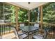 Inviting screened porch with seating and views of the surrounding greenery at 210 Water Oak Way, Louisburg, NC 27549