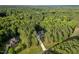 Aerial view of the home surrounded by mature trees and located on a large lot at 2124 Country Air Ln, Hillsborough, NC 27278