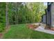 Backyard featuring a green lawn and trees at 2124 Country Air Ln, Hillsborough, NC 27278