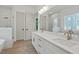 Spacious bathroom with double vanity sinks, soaking tub, and separate shower at 2124 Country Air Ln, Hillsborough, NC 27278