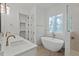 Bright bathroom featuring a soaking tub, shower, double sink vanity, and walk-in closet at 2124 Country Air Ln, Hillsborough, NC 27278