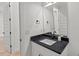 Stylish half bathroom with granite countertop, modern fixtures, and wood floors at 2124 Country Air Ln, Hillsborough, NC 27278