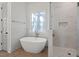 Modern bathroom features a soaking tub and glass-enclosed shower with elegant tile work at 2124 Country Air Ln, Hillsborough, NC 27278
