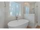 Modern bathroom features a soaking tub and glass-enclosed shower with elegant tile work at 2124 Country Air Ln, Hillsborough, NC 27278