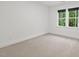 Bright bedroom with neutral carpet and a window offering a beautiful view at 2124 Country Air Ln, Hillsborough, NC 27278