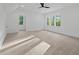 Spacious bedroom with large windows, ceiling fan, and plush carpeting for comfort at 2124 Country Air Ln, Hillsborough, NC 27278
