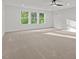 Large, bright bedroom with neutral carpet, white walls, and tree view from three large windows at 2124 Country Air Ln, Hillsborough, NC 27278