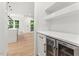 Convenient dry bar area featuring built-in shelves and a beverage center at 2124 Country Air Ln, Hillsborough, NC 27278