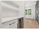 Modern dry bar features floating shelves and a sleek beverage cooler at 2124 Country Air Ln, Hillsborough, NC 27278