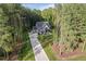 Gorgeous home featuring a manicured front lawn, long driveway and lush trees at 2124 Country Air Ln, Hillsborough, NC 27278