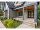 This charming covered porch features stone accents and a natural wood ceiling at 2124 Country Air Ln, Hillsborough, NC 27278