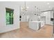 Open-concept kitchen with an island, stainless appliances, and hardwood flooring at 2124 Country Air Ln, Hillsborough, NC 27278