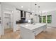 Modern kitchen with a large center island, sleek appliances, and a stylish backsplash at 2124 Country Air Ln, Hillsborough, NC 27278