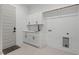 Clean laundry room with white cabinets, sink, and tile floors at 2124 Country Air Ln, Hillsborough, NC 27278