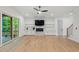 Open living area with fireplace, built-in shelving, and access to outdoor porch through sliding glass doors at 2124 Country Air Ln, Hillsborough, NC 27278