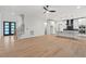 Open-concept living area featuring hardwood floors and a modern kitchen with white cabinetry at 2124 Country Air Ln, Hillsborough, NC 27278