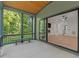 Covered porch with seating, offering serene backyard views and access to the home's interior at 2124 Country Air Ln, Hillsborough, NC 27278
