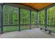 Covered porch with ceiling and outdoor seating that overlooks a lush green backyard at 2124 Country Air Ln, Hillsborough, NC 27278
