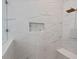 Close-up of a tiled shower with a built-in niche and bench at 2124 Country Air Ln, Hillsborough, NC 27278