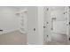Spacious walk-in closet with built-in shelves and access to a modern, tiled bathroom at 2124 Country Air Ln, Hillsborough, NC 27278