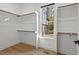 Walk-in closet with built-in shelving, window, and wood floors at 2124 Country Air Ln, Hillsborough, NC 27278