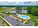 Community pool and pond with surrounding houses and trees are viewed from above at 222 Oak Branch - Lot 72 Trl, Garner, NC 27529