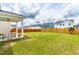 Manicured backyard featuring a lush green lawn, patio area, and wooden fence at 222 Oak Branch - Lot 72 Trl, Garner, NC 27529