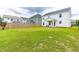 Lush backyard featuring a green lawn, wooden fence, and covered patio at 222 Oak Branch - Lot 72 Trl, Garner, NC 27529