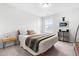Neutral bedroom with queen bed and side table, window, and modern accents at 222 Oak Branch - Lot 72 Trl, Garner, NC 27529